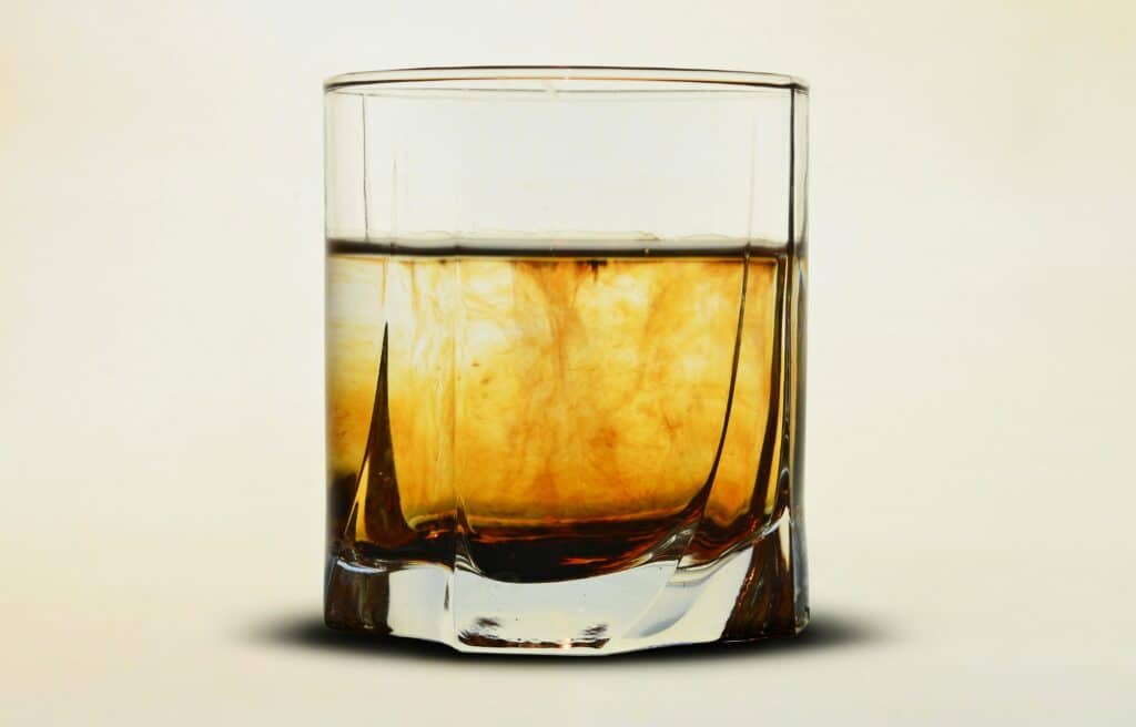 brown liquor in glass