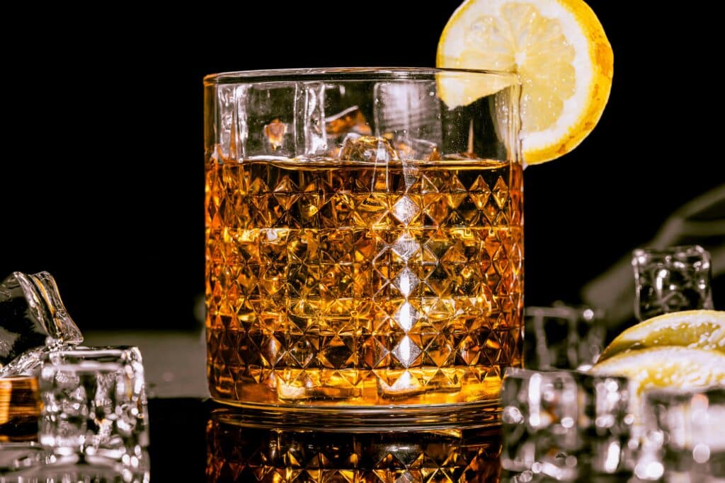 glass of liquor with lemon