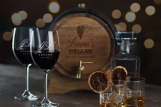 liquor glasses in front of barrel