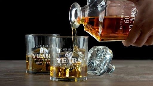 person pouring whiskey into glass